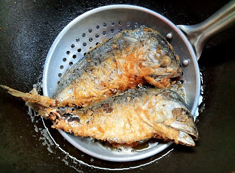 Cooking fried Mackerel fish - food preparation.