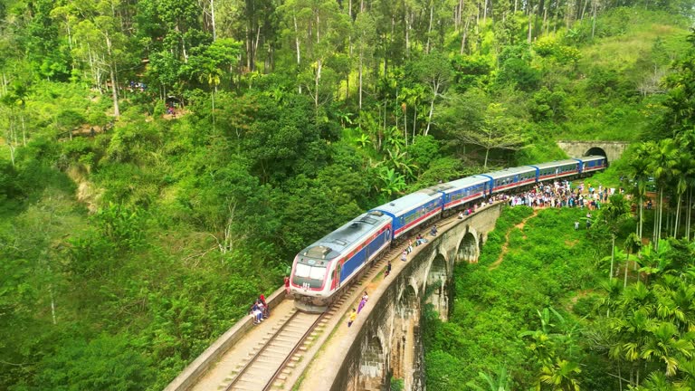 Aerial drone 4k. Scenic train on Nine Arch Bridge. Kandy to Ella railway. South Asia summer tourism.