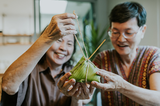 Two senior adult woman enjoy their part time job on retirement life together, doing a small business about delivery food.