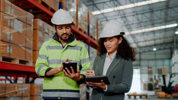 istock Male Warehouse Worker Talking to Auditor about Stocktaking Routine. 1475192537