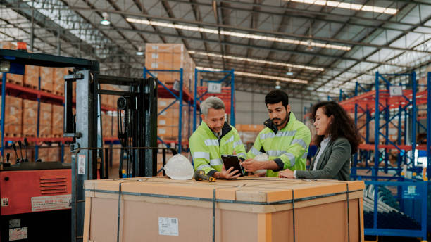 istock Female Auditor Asking Questions to Warehouse Workers During On-site Inspection. 1475192597