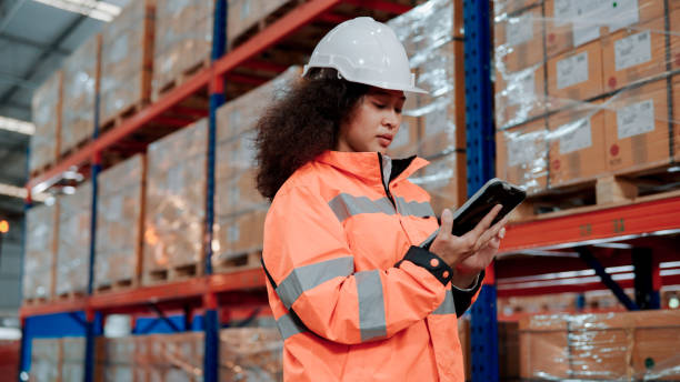 istock Young Asian Warehouse Worker Counting Inventory with Digital Tablet. 1475192602