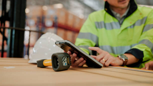 istock Young Asian Warehouse Worker Answering Female Auditor's Question and Explaining Using Digital Tablet. 1475192610