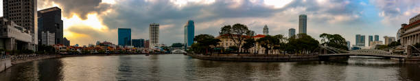 The panoramic view of Boat Quay and the Singapore River on a cloudy day stock photo