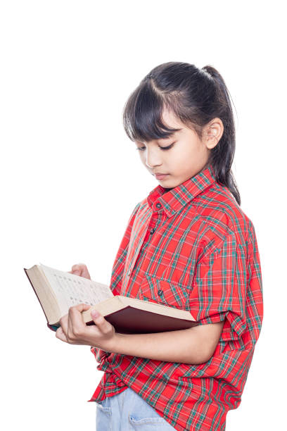 istock Asian girl reading book isolated on white background with clipping path. 1475198488