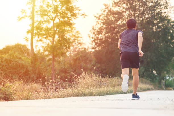 istock Athlete runner feet running on road, Jogging concept at outdoors. Man running for exercise. 1475198501
