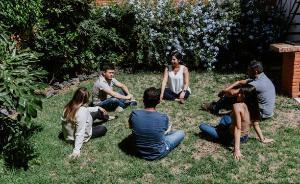 istock hispanic young people seated in circle on grass and participating at group therapy session in Mexico Latin America 1475198869