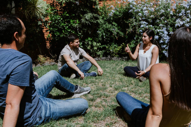 istock hispanic young people seated in circle on grass and participating at group therapy session in Mexico Latin America 1475198870