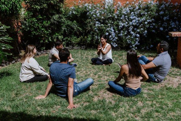 istock hispanic young people seated in circle on grass and participating at group therapy session in Mexico Latin America 1475198955