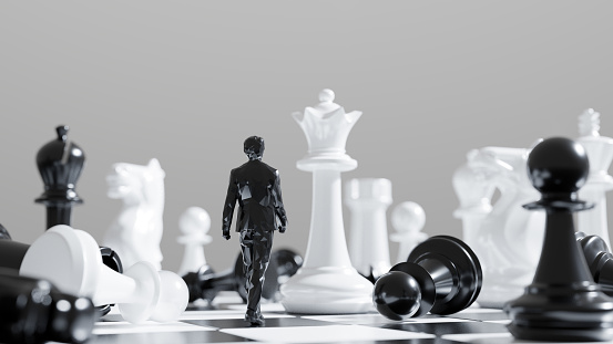 Black figure of a businessman walking at chessboard against white queen chess piece. Leadership concept