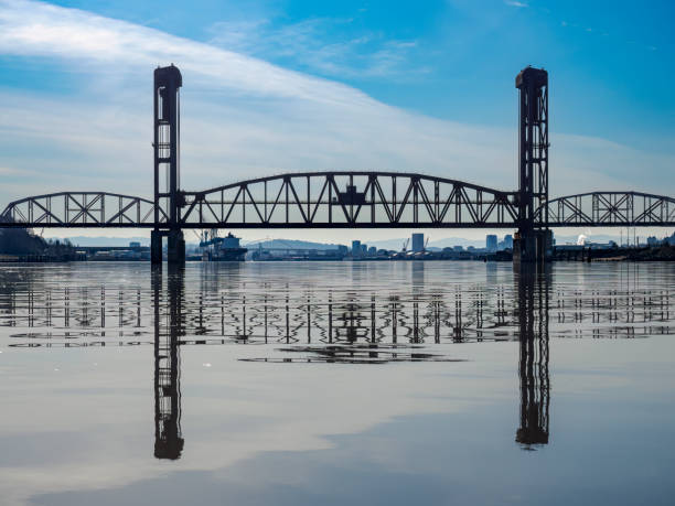 The St. Johns Railroad Bridge aka the Willamette River Railroad Bridge that spans the Willamette River in Portland, Oregon. Behind it and only partly visible, is downtown Portland, Oregon. Edited.