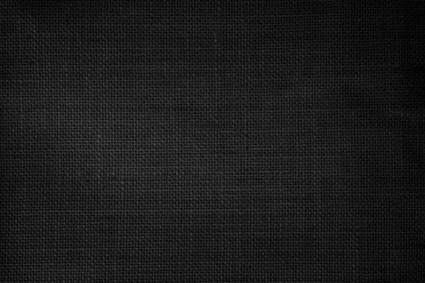 istock Black fabric canvas texture background. Linen dyed black. Sackcloth woven texture pattern background dark black color empty. 1475203298