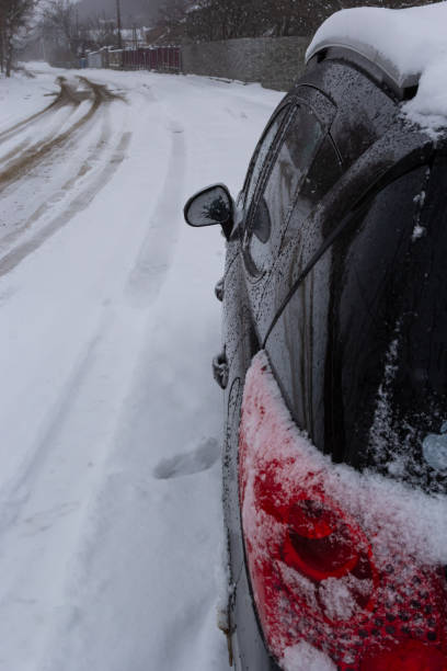 istock rear tail light of car covered in snow after blizzard on winter 1475205813