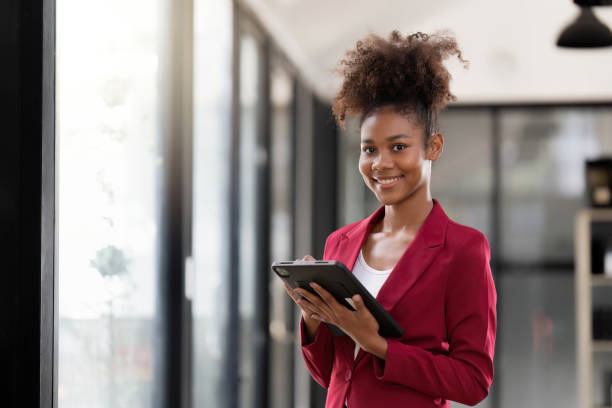 istock Woman on workplace taking information from digital tablet 1475205888