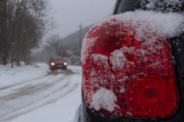 istock rear tail light of car covered in snow after blizzard on winter 1475205889