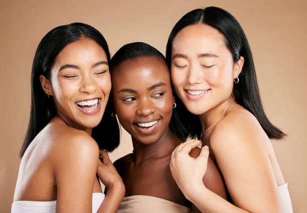 skincare, beauty and diversity, happy women with smile and eyes closed on studio background. health, wellness and luxury cosmetics, healthy skin care and beautiful, friendly people in natural makeup - asian ethnicity fashion model beautiful luxury imagens e fotografias de stock
