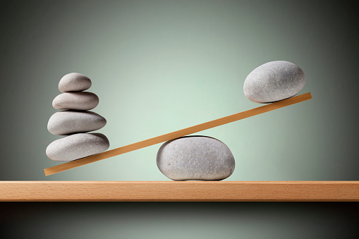 Unbalance concept. Balancing stones on the shelf.