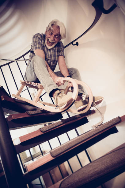 istock Senior Man Going Down Stairs On Sleigh 1475208981