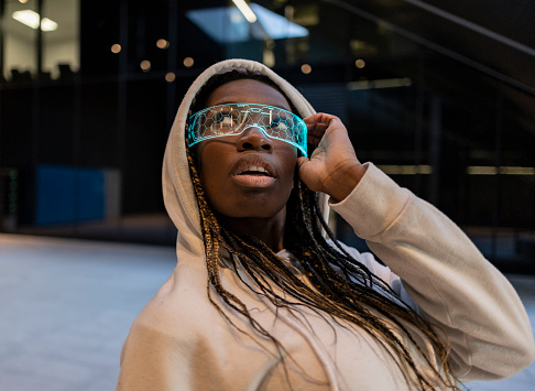 African woman wearing futuristic virtual reality goggles, plunged into a world of endless possibilities and boundless creativity.