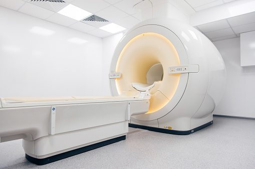 Medical CT, MRI or PET in a modern hospital laboratory. Technologically advanced and functional medical equipment in a clean white room.