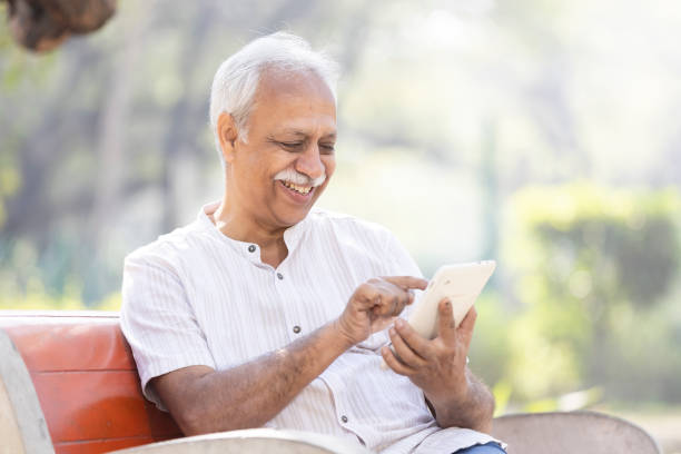 istock Happy senior men using digital tablet at park 1475212535