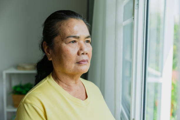 istock Senior woman looking out of window. 1475217232