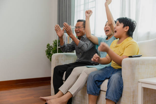istock Multigenerational family watching TV together, fun. 1475218146
