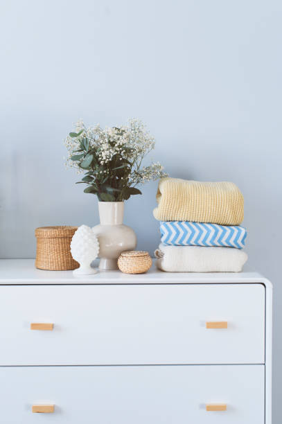 istock white drawer with stack of warm cozy sweaters. Spring home cleaning. Wardrobe organization, lifestyle, comfy home. 1475220939