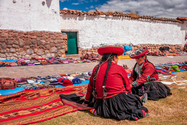 Peruvian women selling souvenirs at Inca ruins, Sacred Valley, Peru The Sacred Valley of the Incas or Urubamba Valley is a valley in the Andes  of Peru, close to the Inca capital of Cusco and below the ancient sacred city of Machu Picchu. The valley is generally understood to include everything between Pisac  and Ollantaytambo, parallel to the Urubamba River, or Vilcanota River or Wilcamayu, as this Sacred river is called when passing through the valley. It is fed by numerous rivers which descend through adjoining valleys and gorges, and contains numerous archaeological remains and villages. The valley was appreciated by the Incas due to its special geographical and climatic qualities. It was one of the empire's main points for the extraction of natural wealth, and the best place for maize production in Peru.http://bem.2be.pl/IS/peru_380.jpg chinchero district stock pictures, royalty-free photos & images