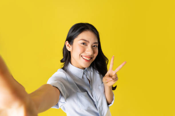 istock Asian woman on yellow background 1475221123