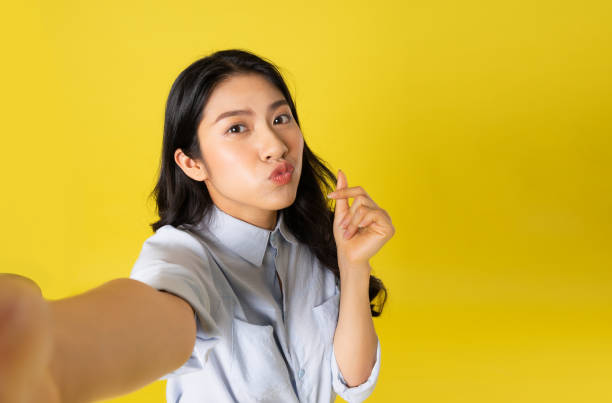 istock Asian woman on yellow background 1475221133