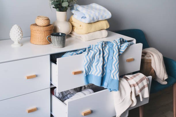 istock white scandi drawer with messy knitted sweaters. Spring home cleaning and wardrobe organization. Sorting clothes. 1475221200