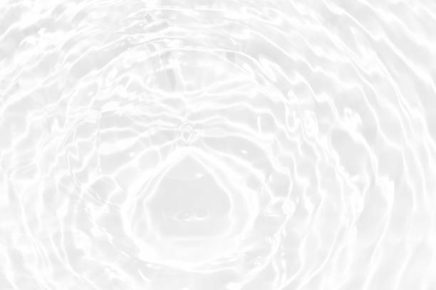 istock Defocus blurred transparent white colored clear calm water surface texture with splashes and bubbles. Trendy abstract nature background. Water waves in sunlight with copy space. White water shine 1475221285