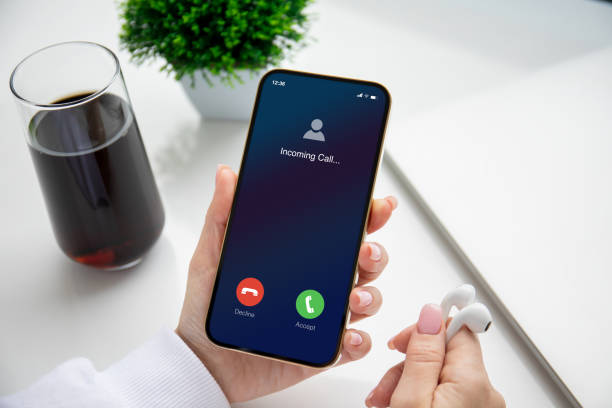 istock female hands holding phone with incoming call on screen 1475221853