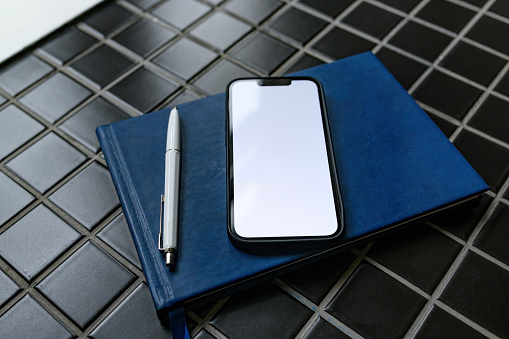 Smartphone mockup with guestbook and pencil in apartment room
