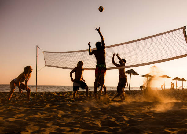 playing volleyball on the beach at sunset! - volleyball beach volleyball beach sport imagens e fotografias de stock