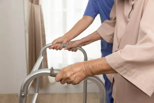 Caregiver takecare old woman that having Sarcopenia or muscle loss. Sarcopenia is a degenerative disease of the muscle usually caused by the natural consequence of aging.