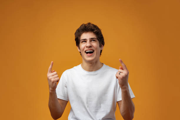 istock Young handsome man over blue background pointing to the side 1475225232