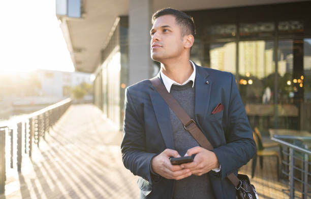 istock City, thinking or business man with phone for internet research, communication or networking. Tech, online or professional in street on 5g smartphone for social network, blog review or media search 1475227002