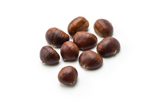 Small group of Chestnut with peel on white background, high angle view studio shot.