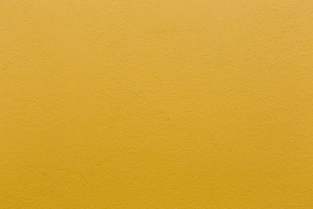 istock Yellow color with an old grunge wall concrete texture as a background. 1475229600