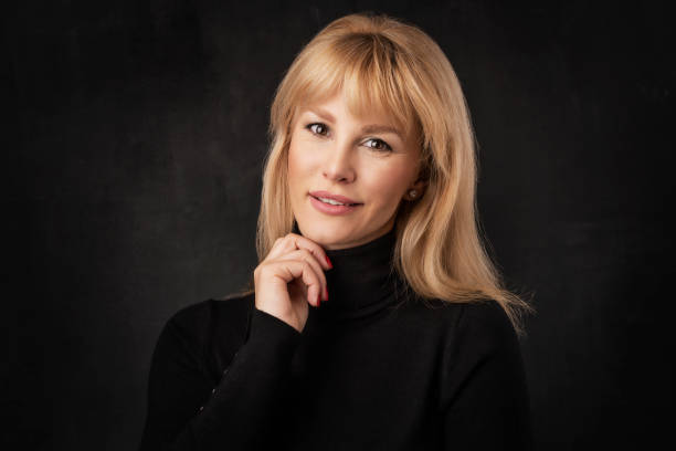 istock Studio portrait of blond haired smiling middle aged woman 1475230241
