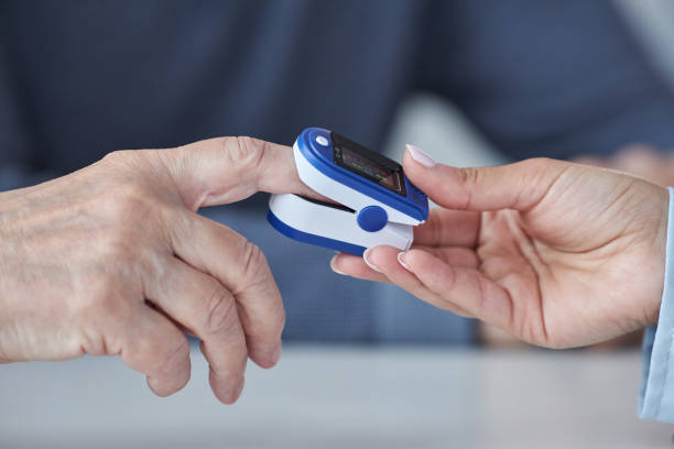 istock Doctor putting pulse oximeter on hand 1475231232