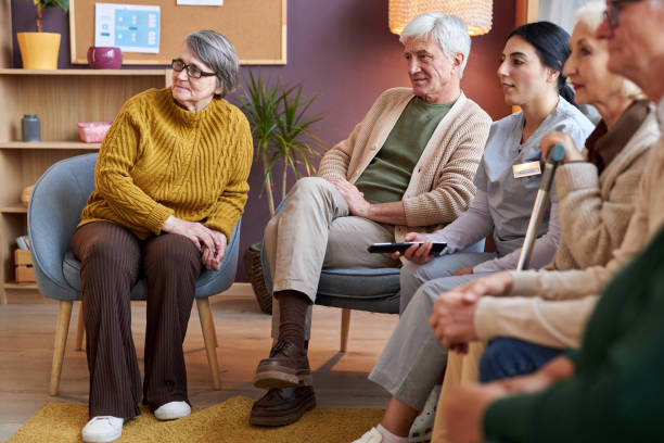 istock Elderly people watching TV in retirement home together 1475231302