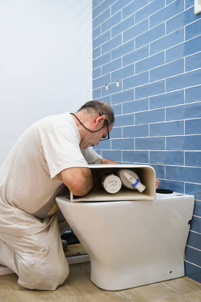istock Senior plumber installer installing toilet cistern. 1475231542