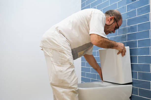 istock Senior plumber installer installing toilet cistern. 1475231664