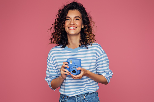 Happy beautiful woman with analog camera