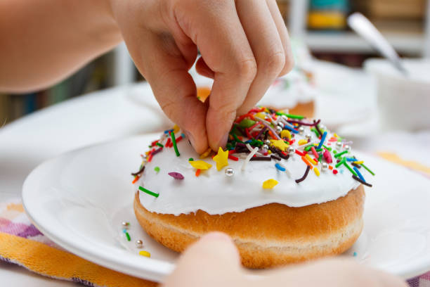 istock Process of decorating a cake with sweet colored decorations 1475233317