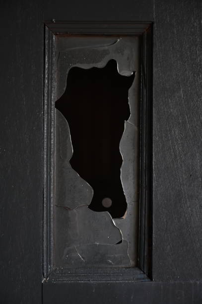 burn dirty black wood door with broken glass texture background