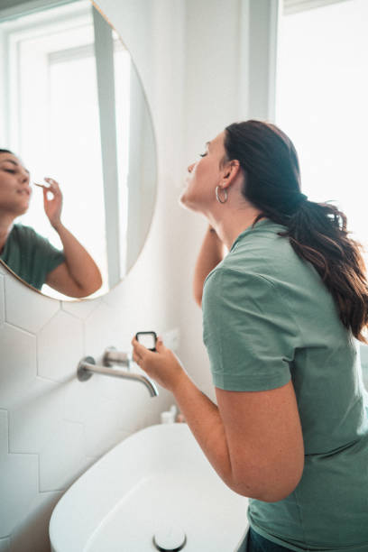 istock woman using make up in the bathroom 1475233563
